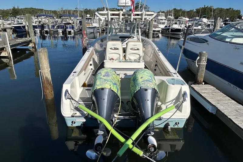 Slide: The Image of 2019 Sailfish 270 CC boat docked at marina with twin outboard engines. - 7