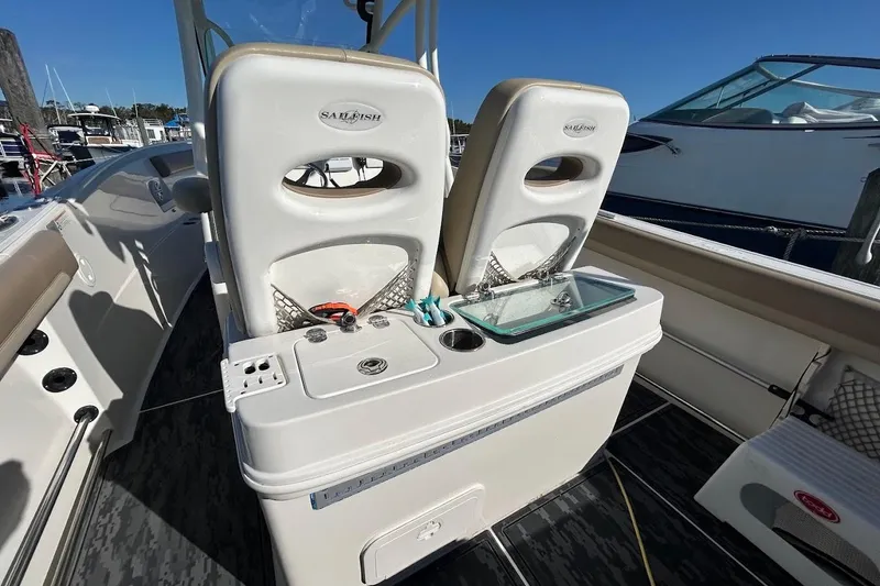 Slide: The Image of 2019 Sailfish 270 CC boat interior with seating and storage compartments. - 9