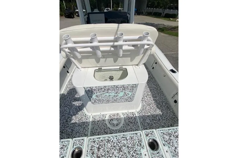 Slide: The Image of 2024 Sea Hunt BX 25 FS boat interior with rod holders and storage compartment. - 10