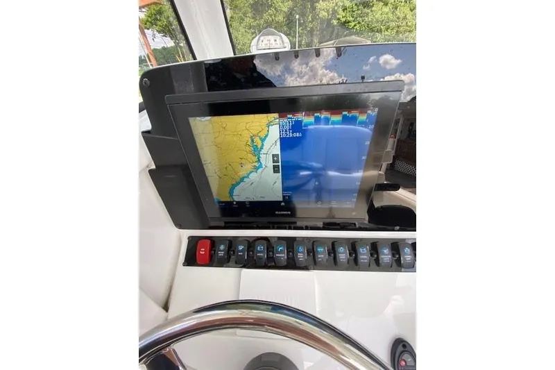 Slide: The Image of 2024 Sea Hunt BX 25 FS boat dashboard with navigation display and controls. - 14