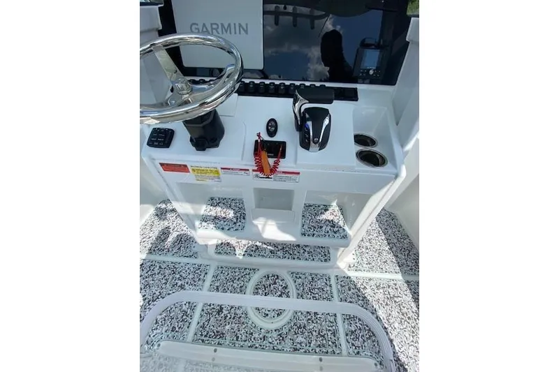 Slide: The Image of 2024 Sea Hunt BX 25 FS boat console with Garmin navigation and steering wheel. - 18