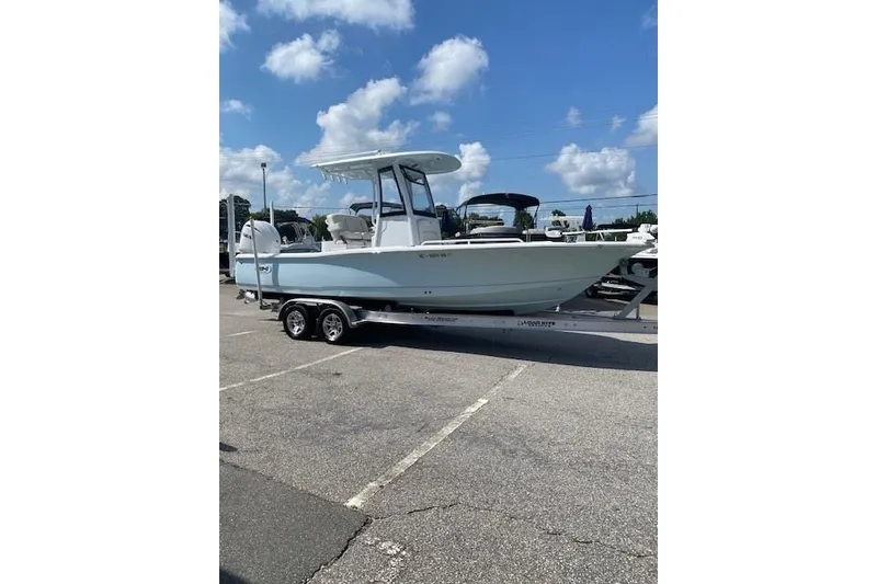 Slide: The Image of 2024 Sea Hunt BX 25 FS boat on trailer under blue sky. - 2