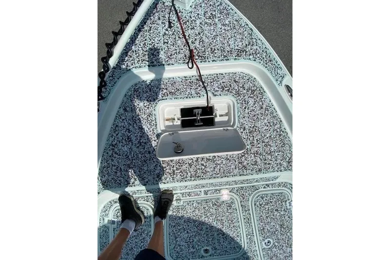 Slide: The Image of 2024 Sea Hunt BX 25 FS boat deck with patterned flooring and open hatch. - 22