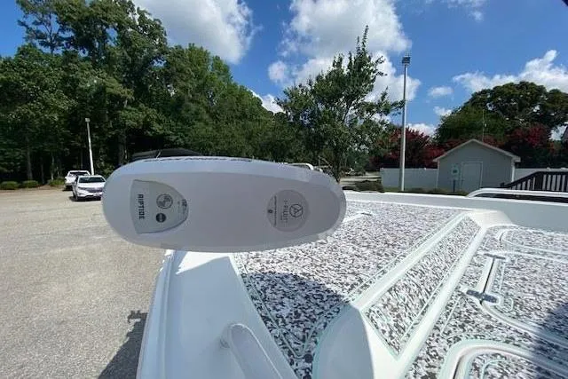 Slide: The Image of 2024 Sea Hunt BX 25 FS boat with Tohatsu motor, parked outdoors under blue sky. - 23