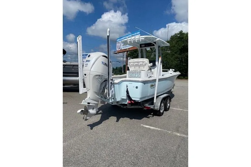 Slide: The Image of 2024 Sea Hunt BX 25 FS boat with Yamaha engine on trailer, parked outdoors. - 3