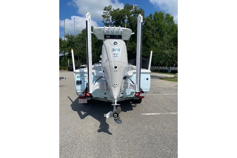 Slide: The Image of 2024 Sea Hunt BX 25 FS boat with powerful 300 V6 engine, parked outdoors. - 4