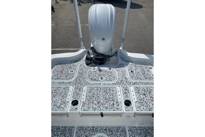 Slide: The Image of 2024 Sea Hunt BX 25 FS boat deck with patterned flooring and motor. - 6