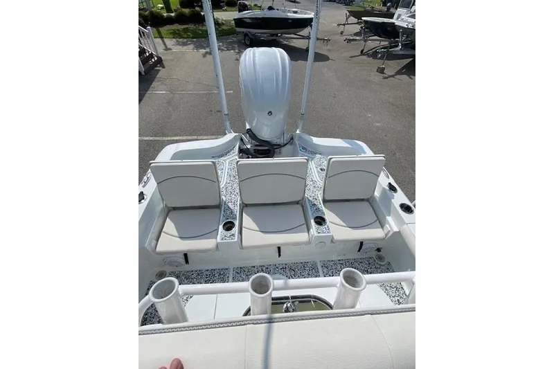 Slide: The Image of 2024 Sea Hunt BX 25 FS boat with three cushioned seats and rod holders. - 7