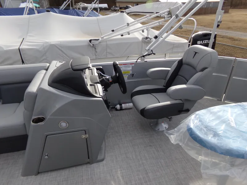 Slide: The Image of 2023 Trifecta 20C CS boat interior with steering console and cushioned captain's chair. - 12
