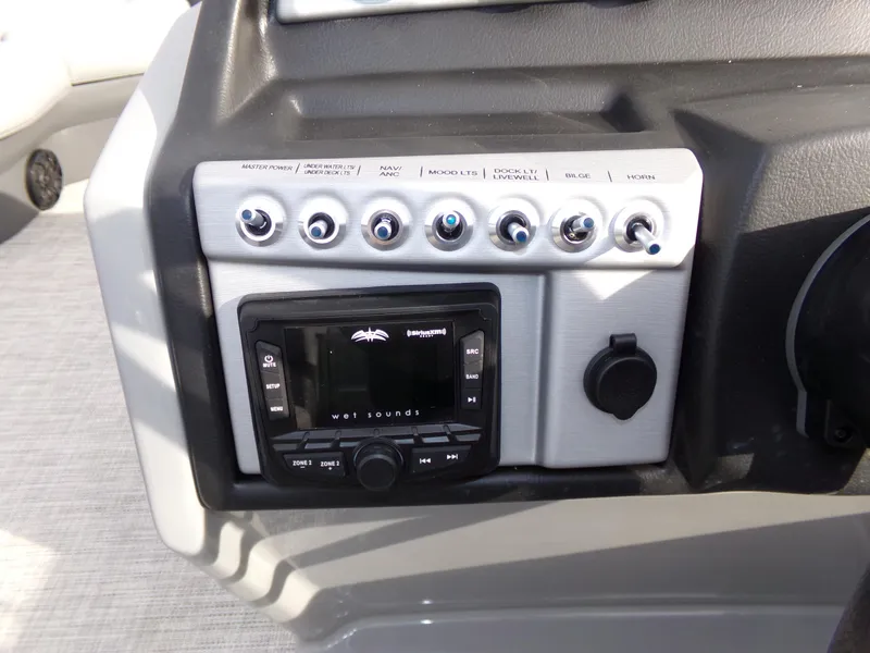 Slide: The Image of Control panel of 2023 Trifecta 20C CS boat with audio system and switches. - 17