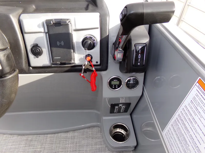 Slide: The Image of Control panel of 2023 Trifecta 20C CS boat with steering and throttle controls. - 18