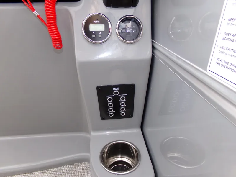 Slide: The Image of Dashboard of 2023 Trifecta 20C CS boat with gauges and cup holder. - 19