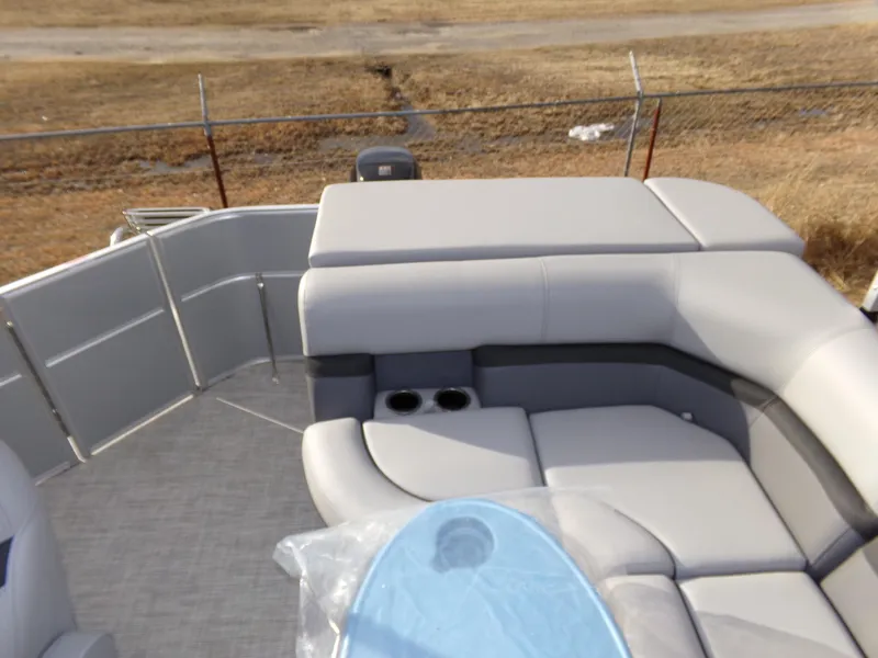 Slide: The Image of 2023 Trifecta 20C CS pontoon boat with gray seating and cup holders. - 21