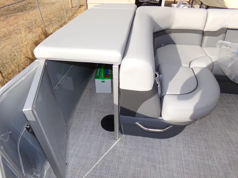 Slide: The Image of 2023 Trifecta 20C CS pontoon boat with gray seating and storage compartment. - 22