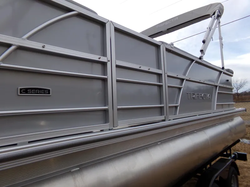 Slide: The Image of 2023 Trifecta 20C CS pontoon boat, C Series, side view with sleek aluminum design. - 4