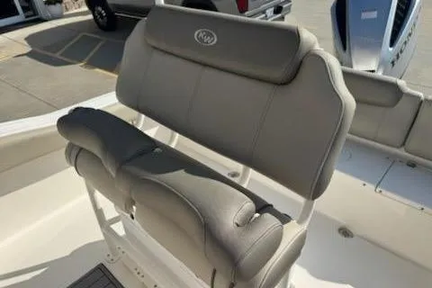 Slide: The Image of 2024 Key West 219 FS boat seating with gray upholstery, outdoor setting. - 10