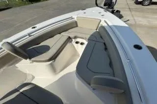Slide: The Image of 2024 Key West 219 FS boat interior with cushioned seating and cup holders. - 14