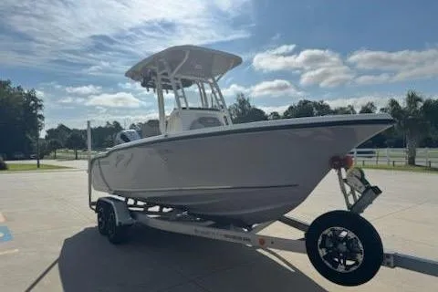 Slide: The Image of 2024 Key West 219 FS boat on trailer under a sunny sky. - 6