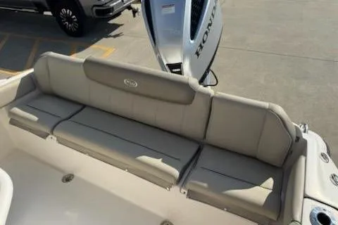 Slide: The Image of 2024 Key West 219 FS boat with comfortable rear seating and Honda outboard motor. - 7