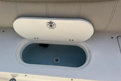 Slide: The Image of 2024 Key West 219 FS boat storage compartment with open lid. - 9