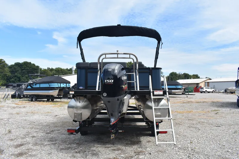 Slide: The Image of 2026 Godfrey Sweetwater 2086C Tritoon with Yamaha engine, parked on gravel lot. - 3