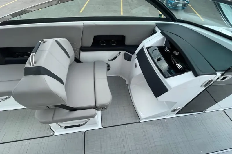 Slide: The Image of 2026 Four Winns H9 boat interior with modern seating and sleek dashboard design. - 12