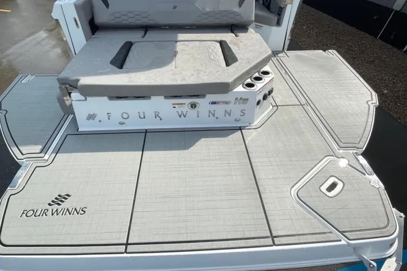 Slide: The Image of 2026 Four Winns H9 boat deck with seating and logo, showcasing modern design. - 16