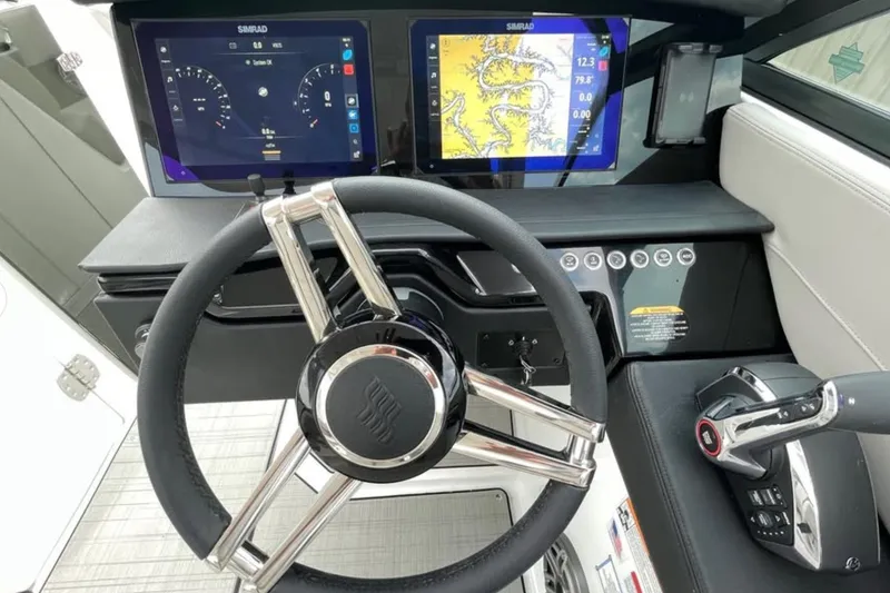 Slide: The Image of 2026 Four Winns H9 helm with dual Simrad displays and modern steering wheel. - 9