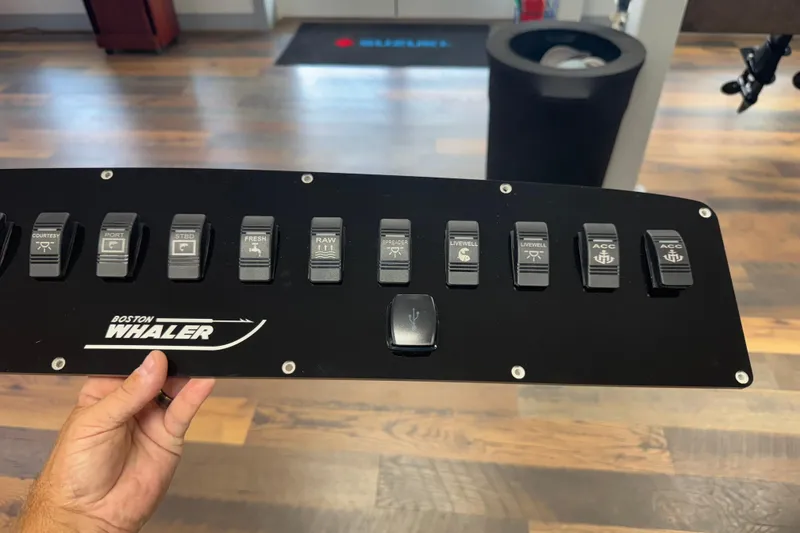 Slide: The Image of Control panel of a 2003 Boston Whaler 240 Outrage boat with labeled switches. - 4