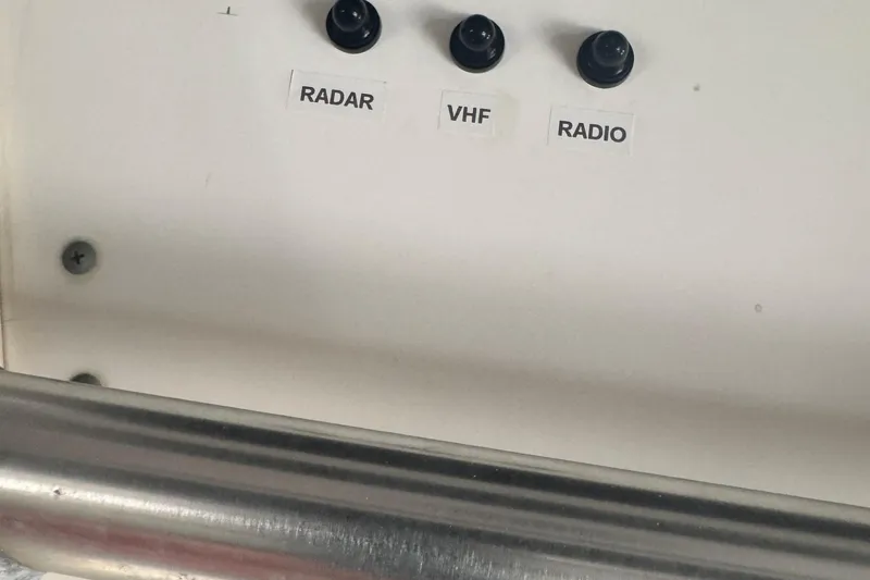 Slide: The Image of Control panel of a 2003 Boston Whaler 240 Outrage with radar, VHF, and radio switches. - 5