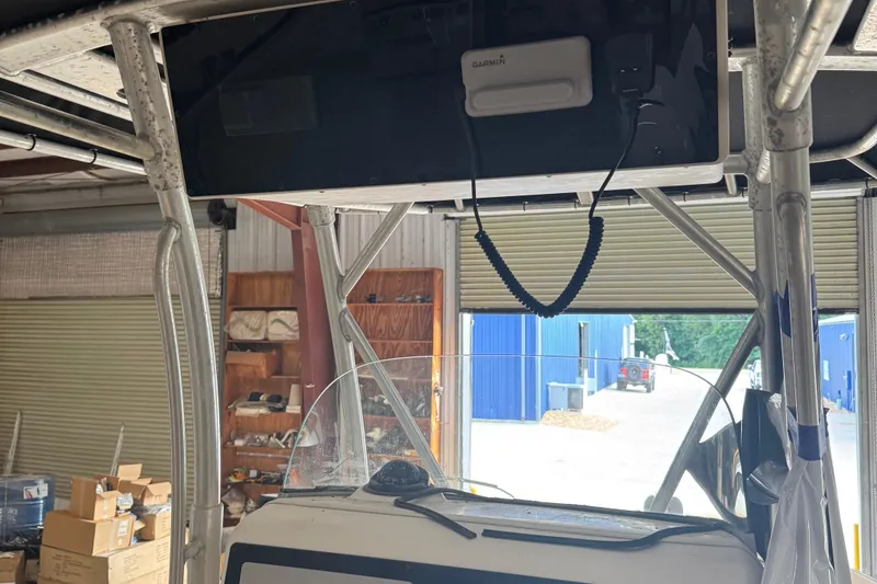 Slide: The Image of 2003 Boston Whaler 240 Outrage boat interior with Garmin equipment in a storage facility. - 8