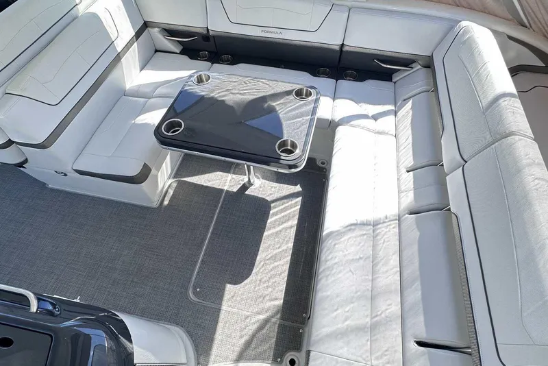 Slide: The Image of 2018 Formula 350 Sun Sport boat interior with white seating and central table. - 12
