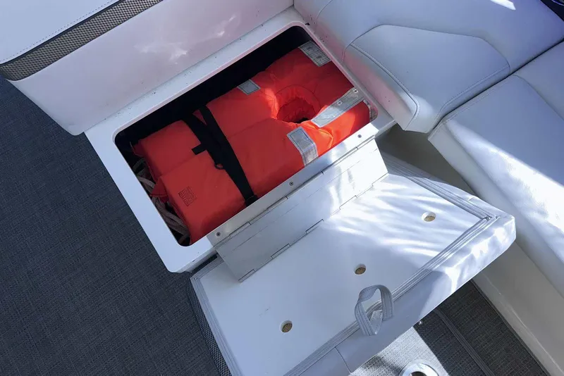 Slide: The Image of Storage compartment with life jackets on a 2018 Formula 350 Sun Sport boat. - 13