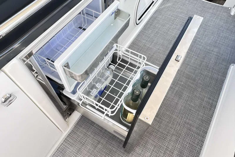 Slide: The Image of Open drawer refrigerator on 2018 Formula 350 Sun Sport boat, storing bottles and beverages. - 18