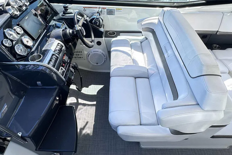 Slide: The Image of 2018 Formula 350 Sun Sport cockpit with luxurious white seating and advanced control panel. - 23