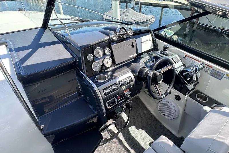 Slide: The Image of 2018 Formula 350 Sun Sport boat cockpit with steering wheel and control panel. - 27