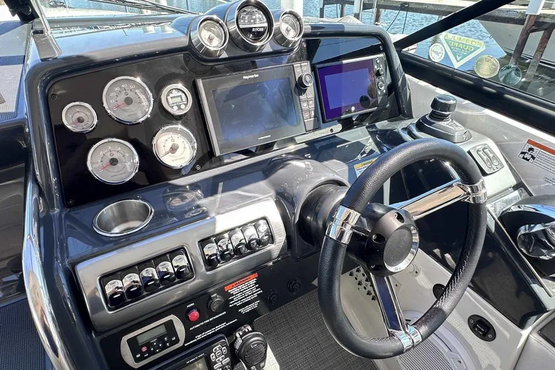 Slide: The Image of 2018 Formula 350 Sun Sport dashboard with steering wheel, gauges, and navigation screens. - 28