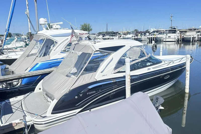 Slide: The Image of 2018 Formula 350 Sun Sport boat docked at a marina, featuring sleek design and canopy. - 3