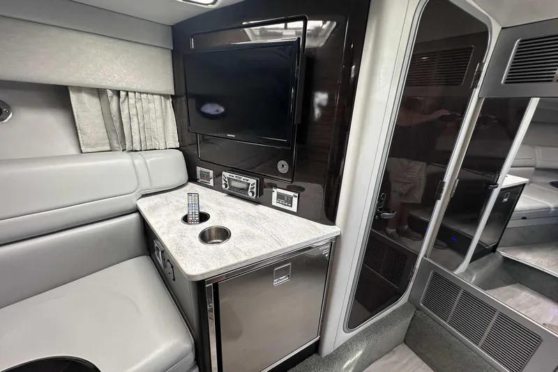 Slide: The Image of Interior of 2018 Formula 350 Sun Sport boat with seating, TV, and mini-fridge. - 33