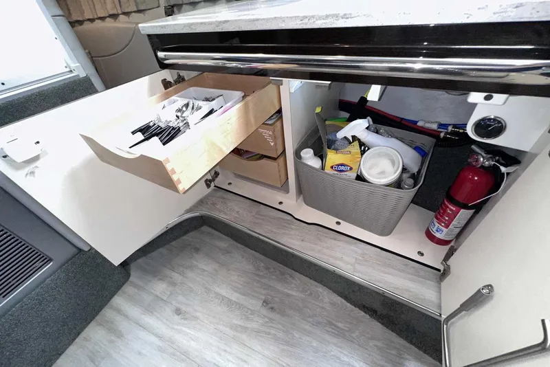 Slide: The Image of Open cabinet in 2018 Formula 350 Sun Sport, showing organized storage with cleaning supplies and utensils. - 37