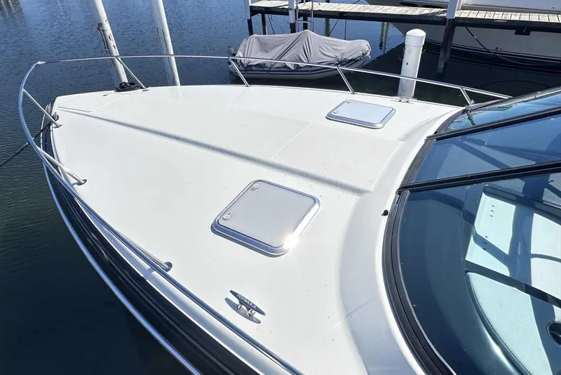 Slide: The Image of 2018 Formula 350 Sun Sport boat docked, showcasing sleek design and spacious deck. - 4