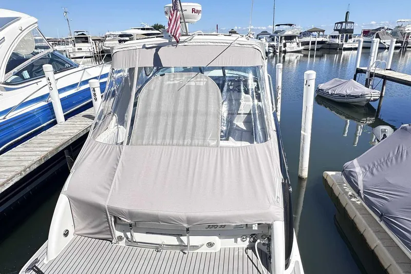 Slide: The Image of 2018 Formula 350 Sun Sport boat docked in a marina, covered and ready for use. - 6