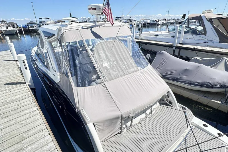 Slide: The Image of 2018 Formula 350 Sun Sport boat docked at marina with protective cover. - 7