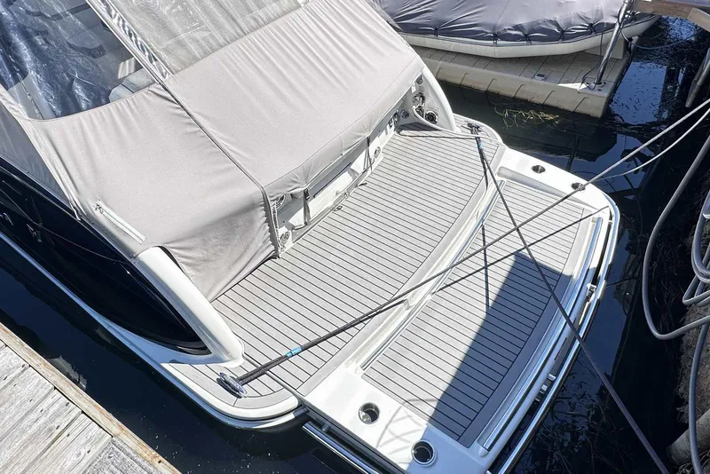 Slide: The Image of 2018 Formula 350 Sun Sport boat docked with covered deck and sleek design. - 8