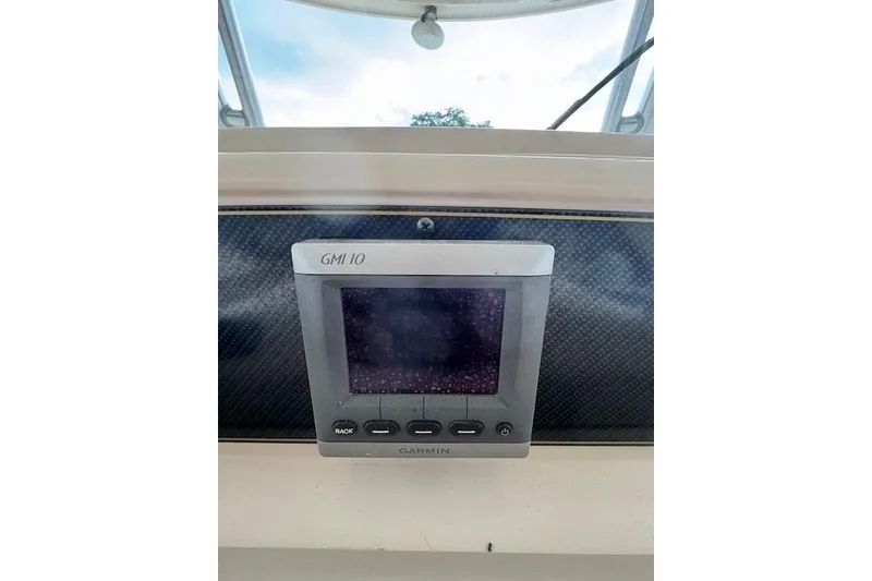 Slide: The Image of Garmin GMI 10 display on 2011 Grady-White Canyon 306 boat dashboard. - 13
