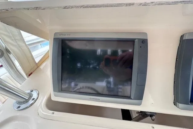Slide: The Image of Garmin GPS display on 2011 Grady-White Canyon 306 boat dashboard. - 14