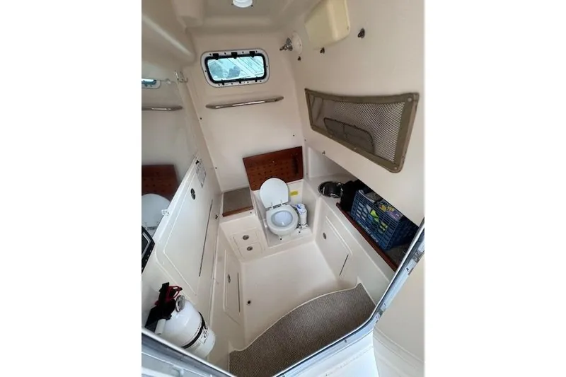 Slide: The Image of 2011 Grady-White Canyon 306 boat interior with toilet and storage compartments. - 16