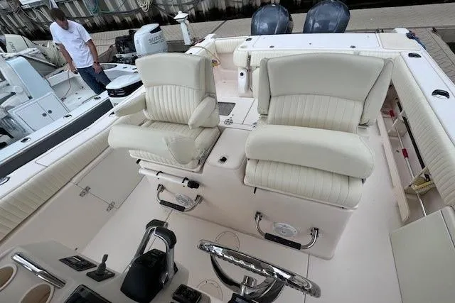 Slide: The Image of 2011 Grady-White Canyon 306 boat interior with dual seats and steering console. - 17
