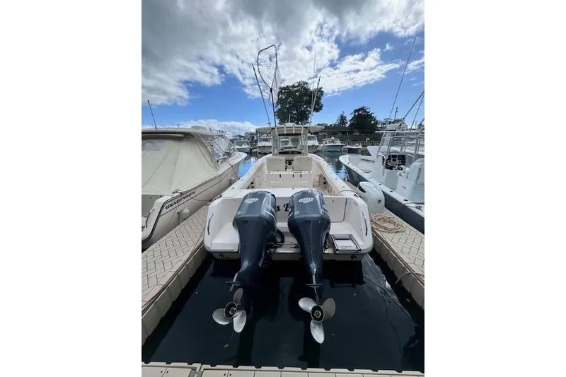 Slide: The Image of 2011 Grady-White Canyon 306 boat docked with twin outboard engines. - 2