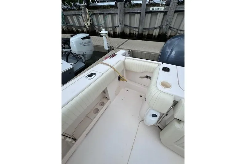 Slide: The Image of 2011 Grady-White Canyon 306 boat interior with seating and Suzuki outboard motor. - 22